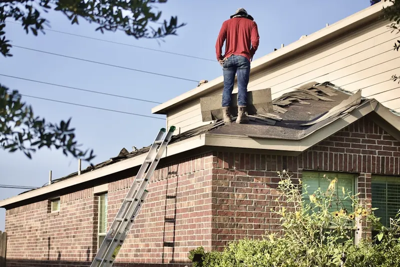 Professional roofer working on a residential roof in Ramsey